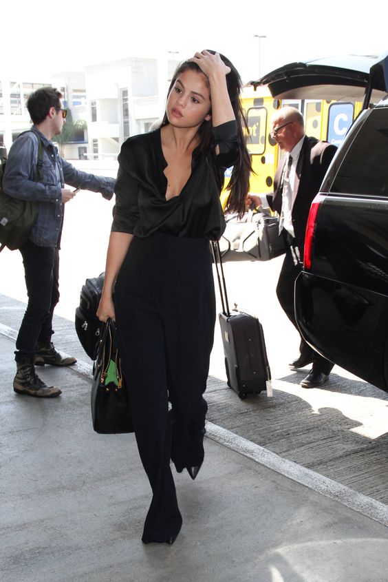August 18, 2015: Selena Gomez in high-waisted pants arrives at LAX Airport in Los Angeles, CA. Mandatory Credit: INFphoto.com Ref.: inf-00