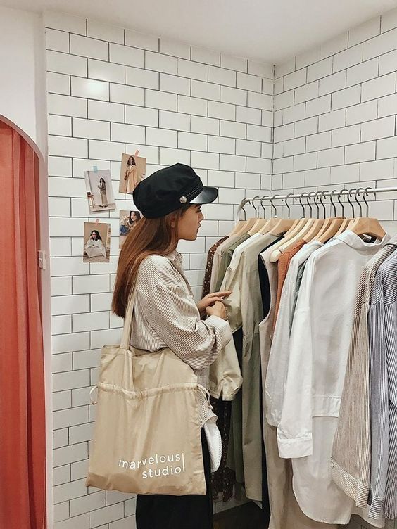 Korean girl wearing a hat and shopping for sweaters