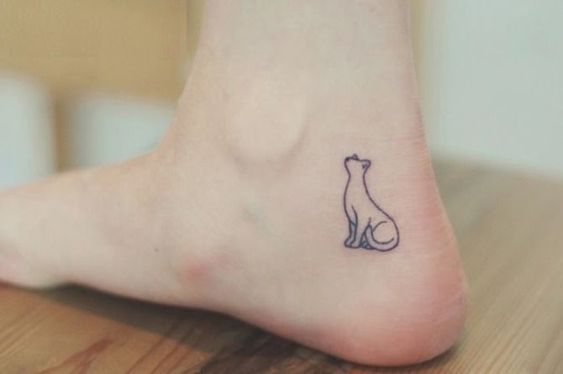 Girl with a small and minimalist ankle tattoo of a cat
