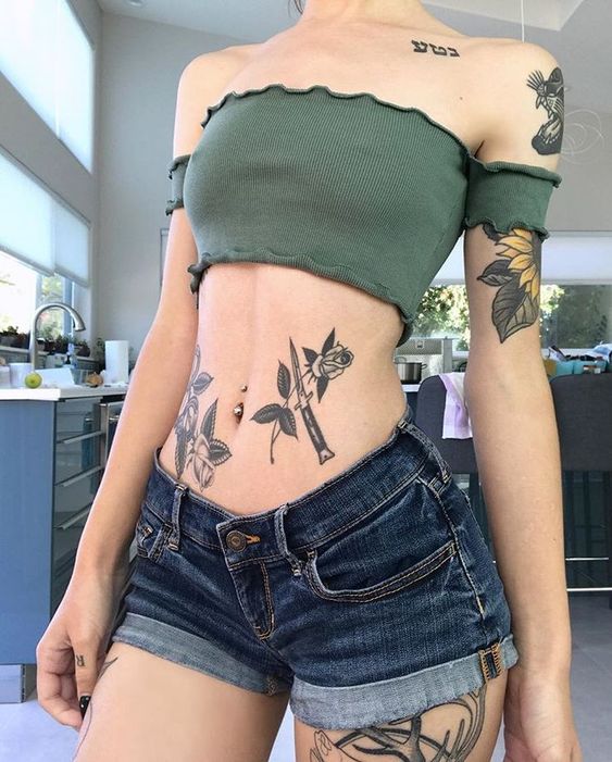 Girl with a floral stomach tattoo