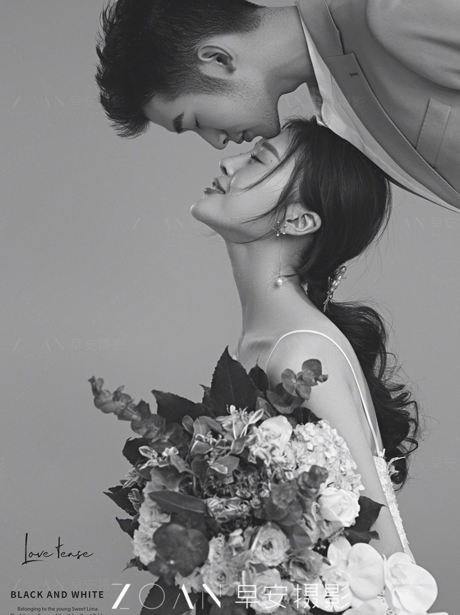 Groom kisses bride on the forehead