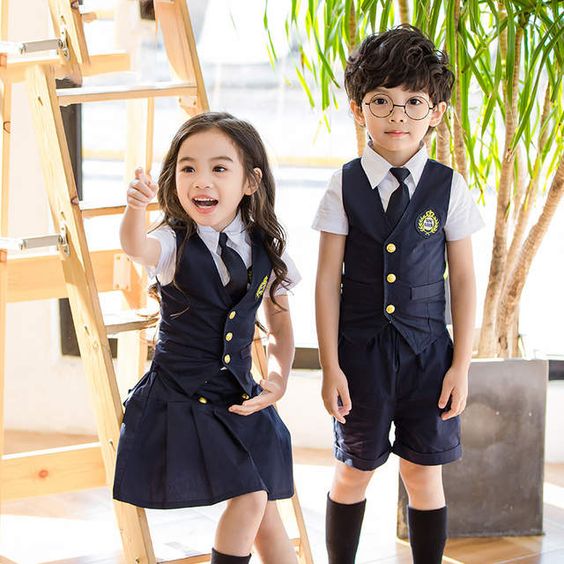 Two Asian children, a girl and body, wearing matching school uniforms
