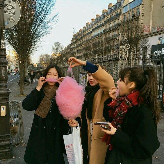 three girls eating cotton candy