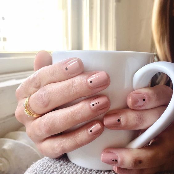 nails with dots and a neutral colour at the base