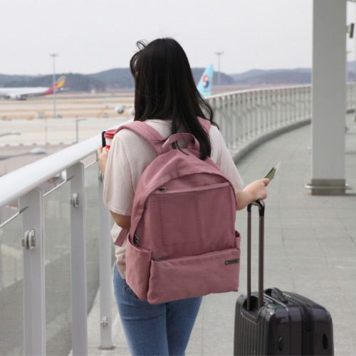Back view of girl travelling alone with suitcase