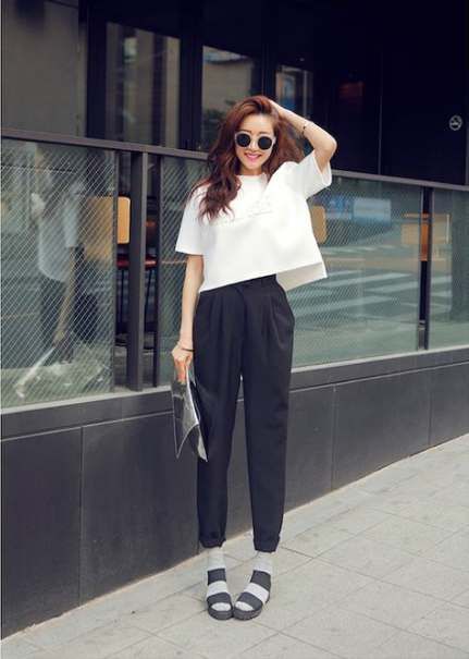 asian woman wearing a white top and black trousers