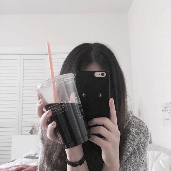 girl holding coffee and phone
