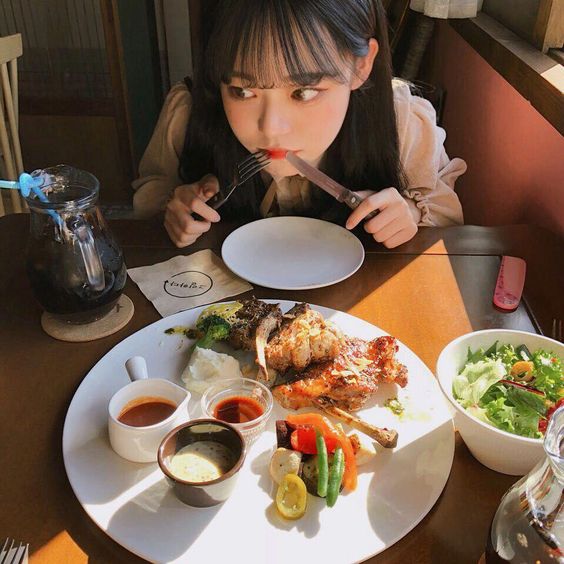 Korean girl having a healthy meal with salad