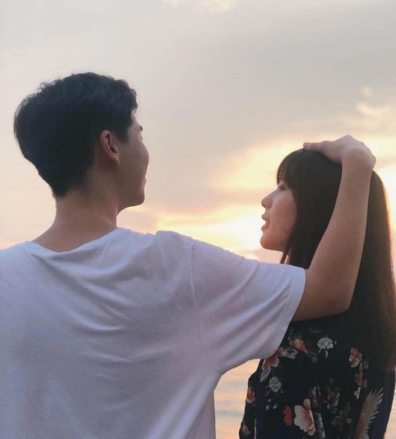 Boyfriend patting girlfriend on her head