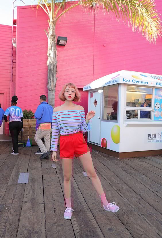 korean girl wearing a striped off shoulder top and red shorts