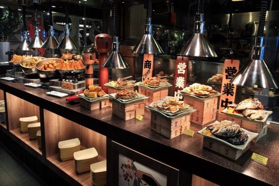 Asian buffet spread with dishes like Japanese food