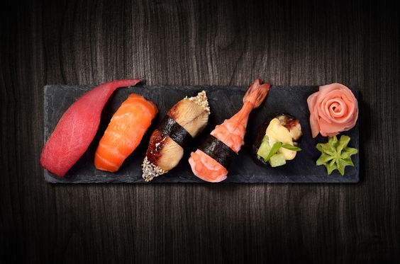 a plate of a few different types of sushi