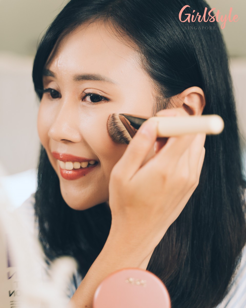 model applying matte blush and bronzer