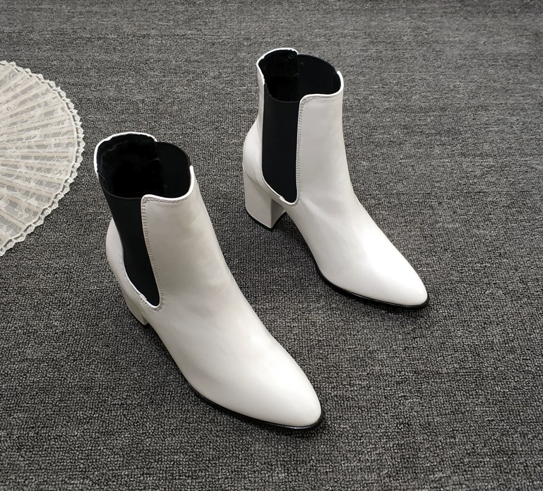 Pointed toe heeled boots in white side view
