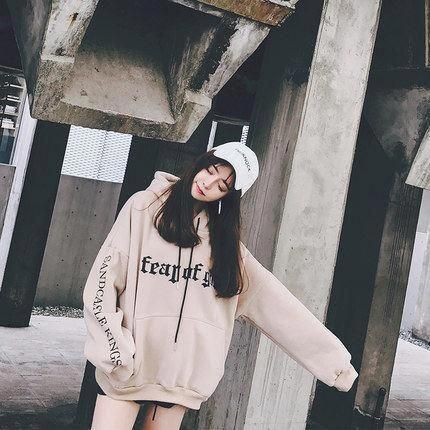 korean girl wearing an oversized sweatshirt and a cap