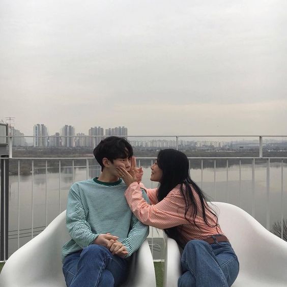 Girlfriend squeezing her boyfriend's face