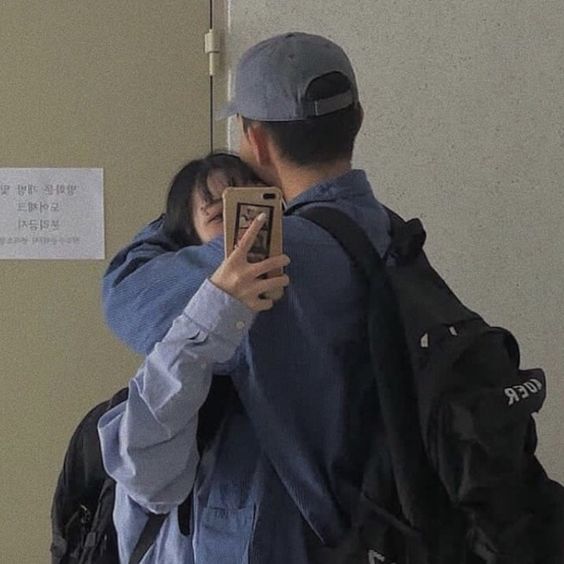 Couple hugging and taking a photo