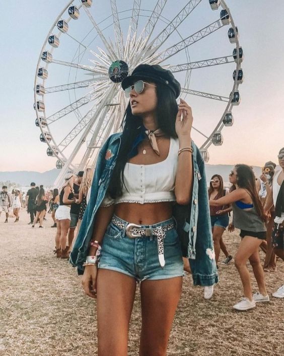 girl wearing crop top, shorts, sunglasses and a lot of jewellery