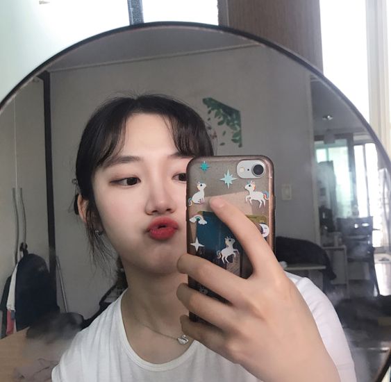 girl taking selfie with phone