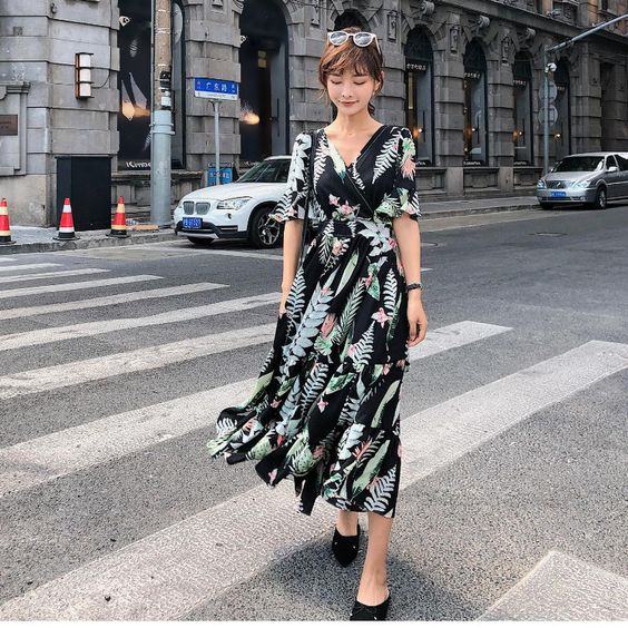 asian woman wearing a long V-neck dress + heels