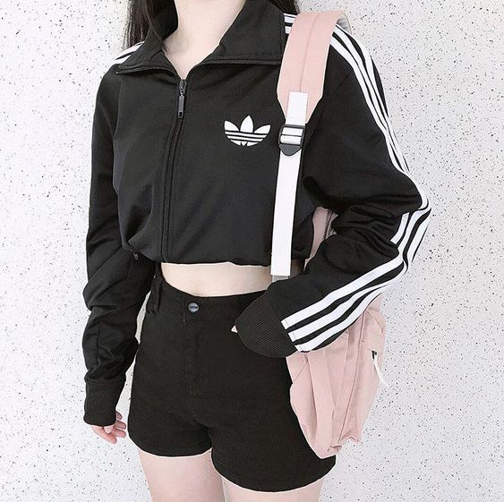 girl wearing adidas athleisure and a pink bag