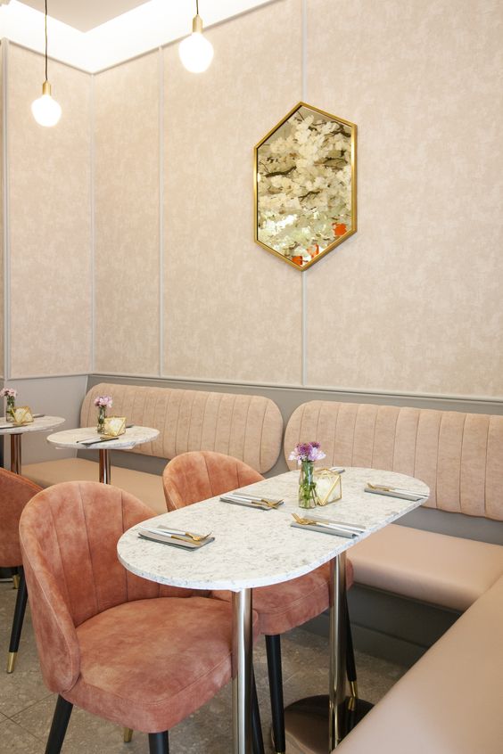 Pink chairs and marble tables in FEYA