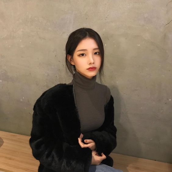 girl in black jacket and striped turtleneck