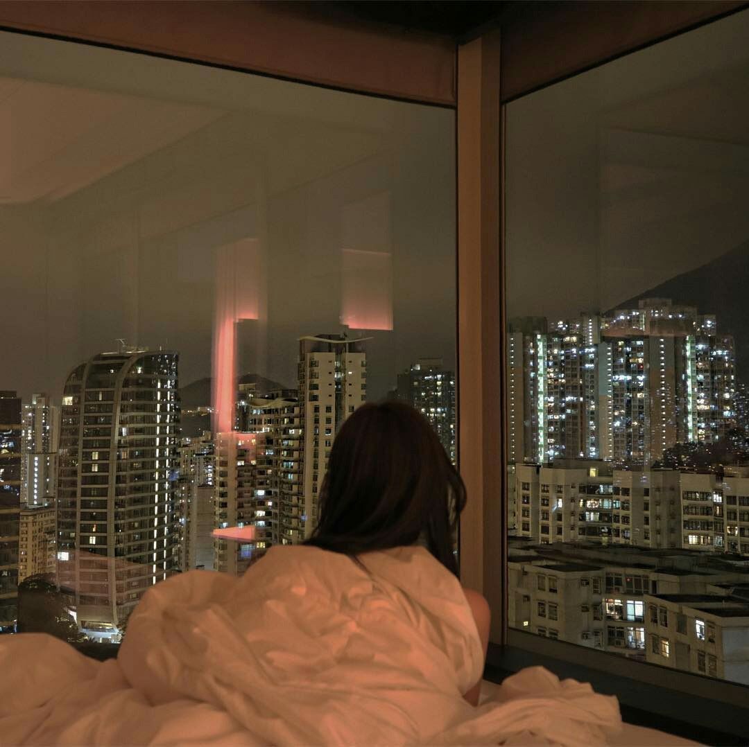 Girl in bed looking out of window