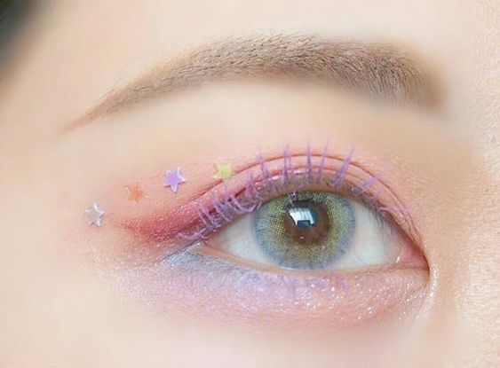 glittery purple eye makeup with chunky star glitters