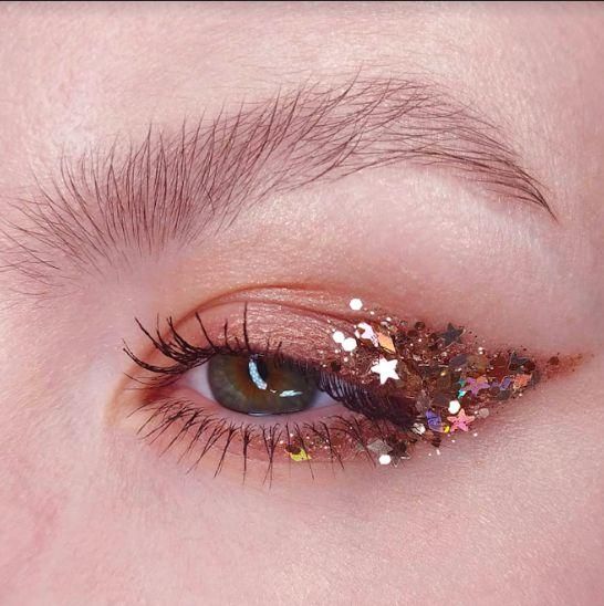 brown eye makeup with winged chunky glitter