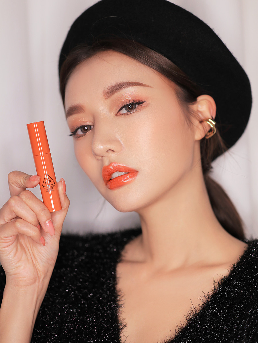 Glaze Lip Tint in mood ring shade with mode; holding the product