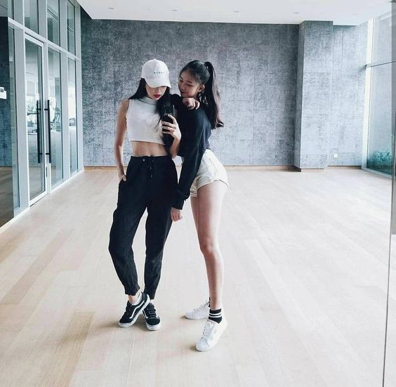 Two girls taking a photo in front of the mirror