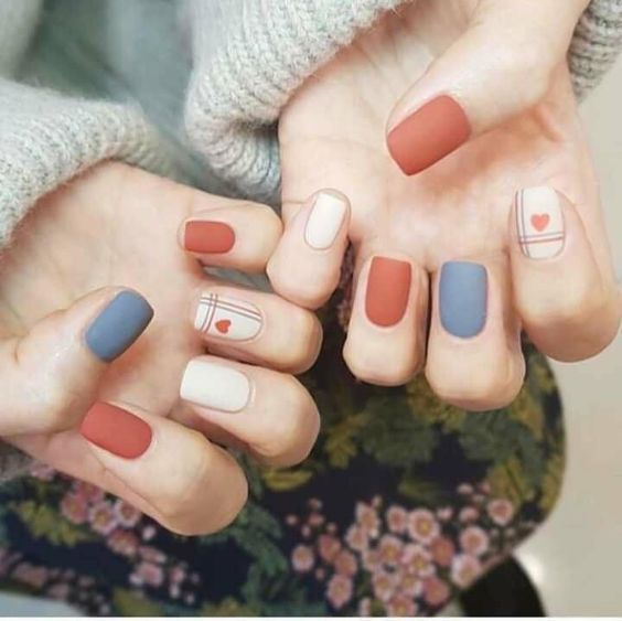 Orange and blue matte nails with heart design