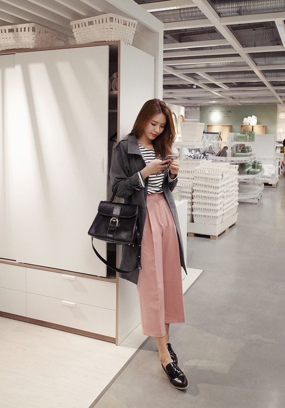 asian woman wearing a black jacket and pink pants