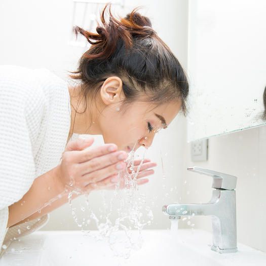 Lady washing her face