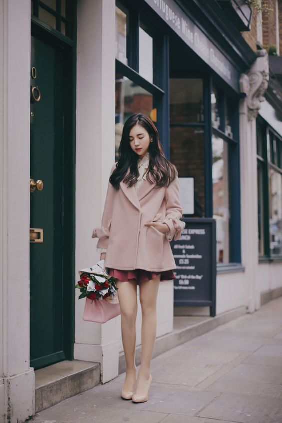 asian woman wearing a pink blazer