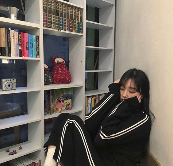 asian girl wearing a tracksuit in a library