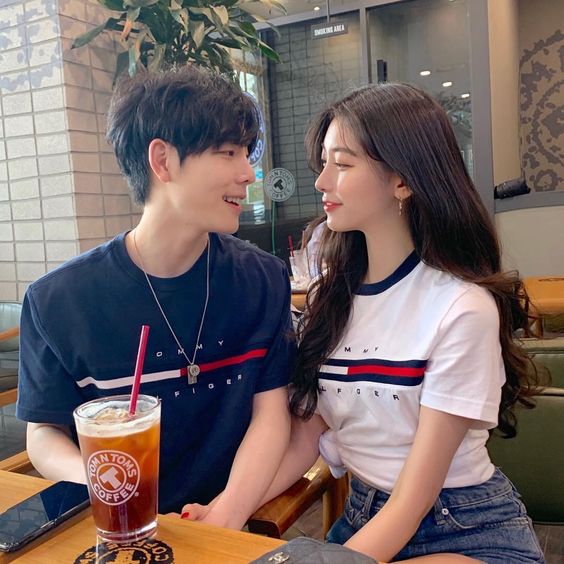 Couple sitting in a cafe looking at each other