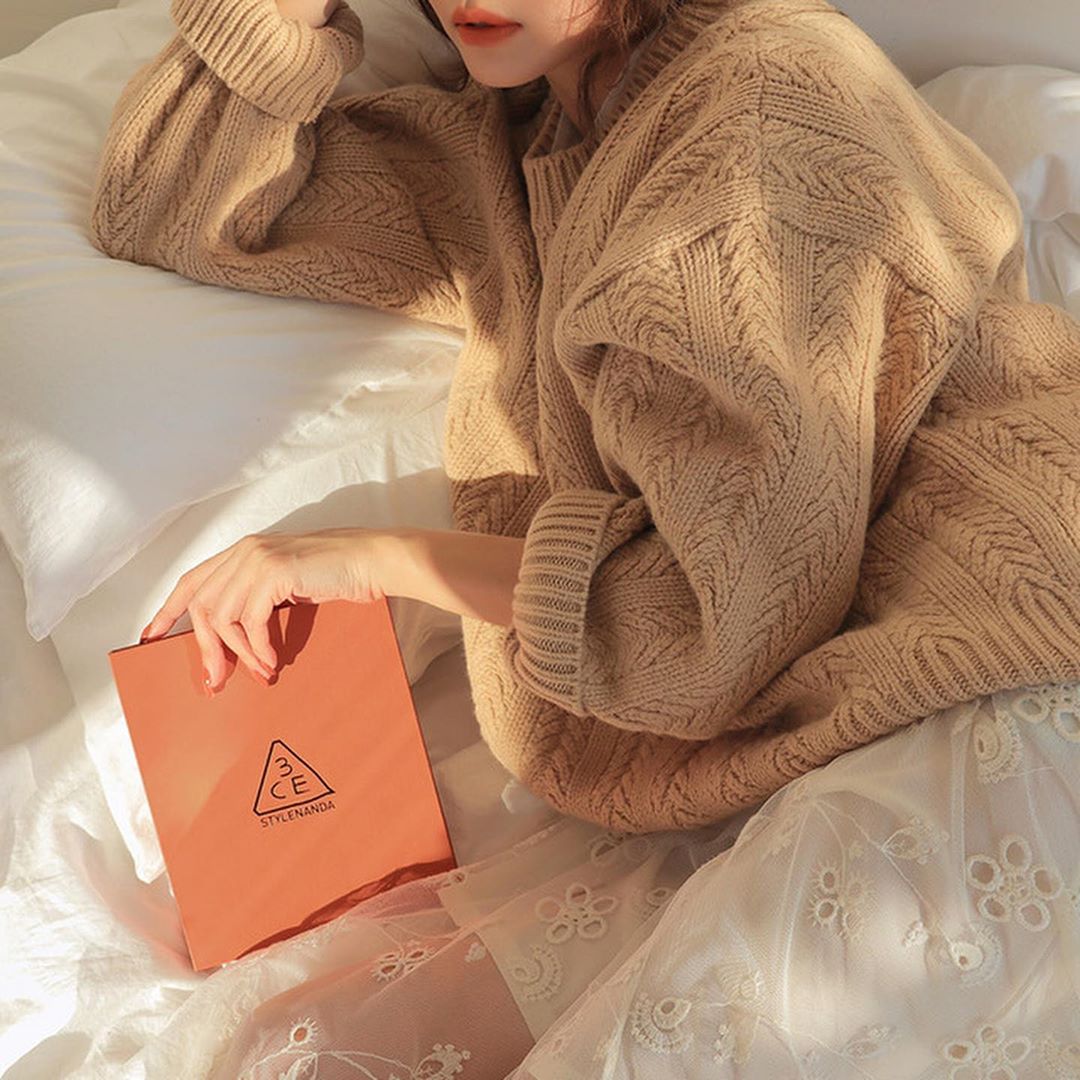 girl holding orange book