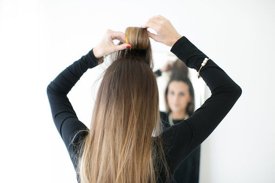 girl using velcro rollers on crown of head