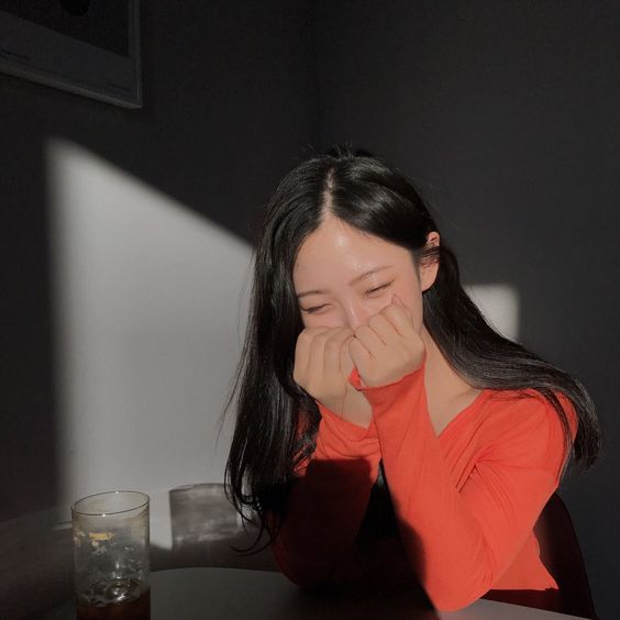 Girl covering her mouth with her fists