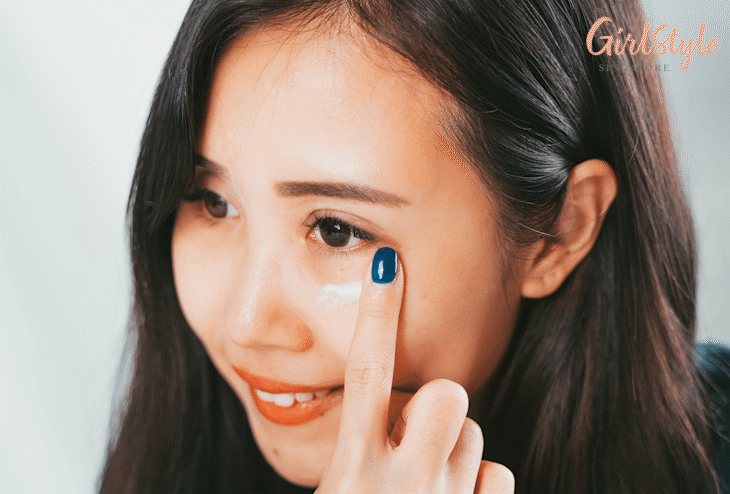 Model applying eye contour cream on under eye