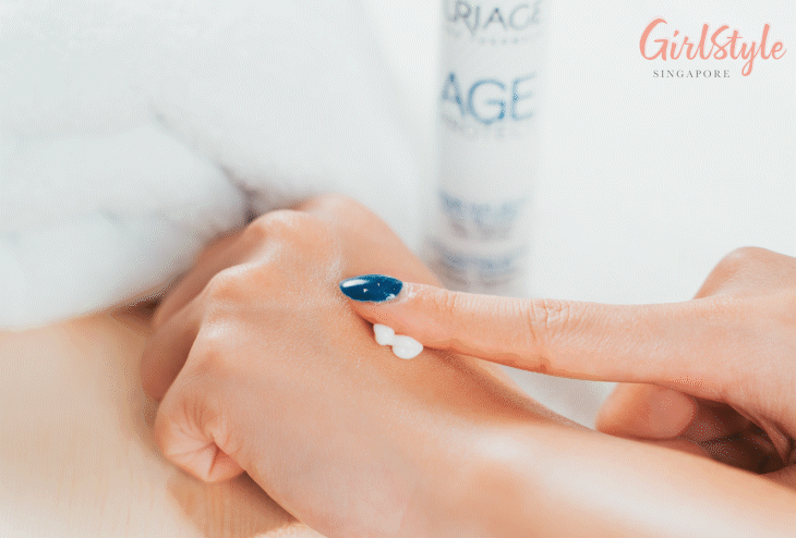 Model applying serum on her hand