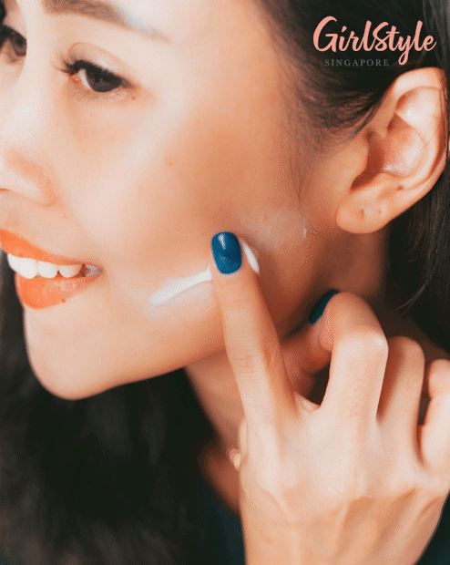 Model applying multi-action cream on skin