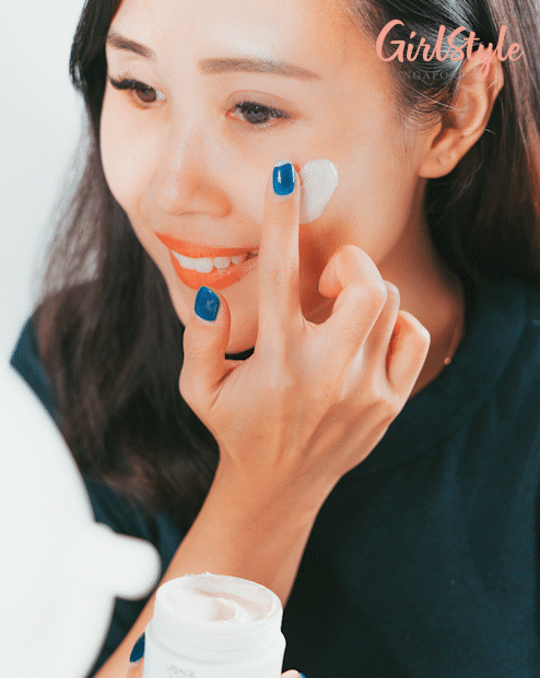 Model applying peeling cream on the face