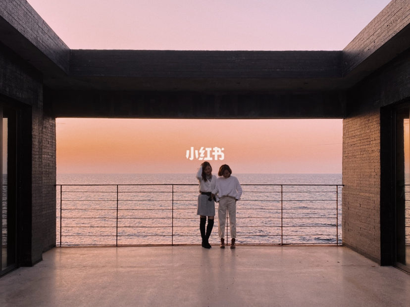 Two girls looking out to the sea