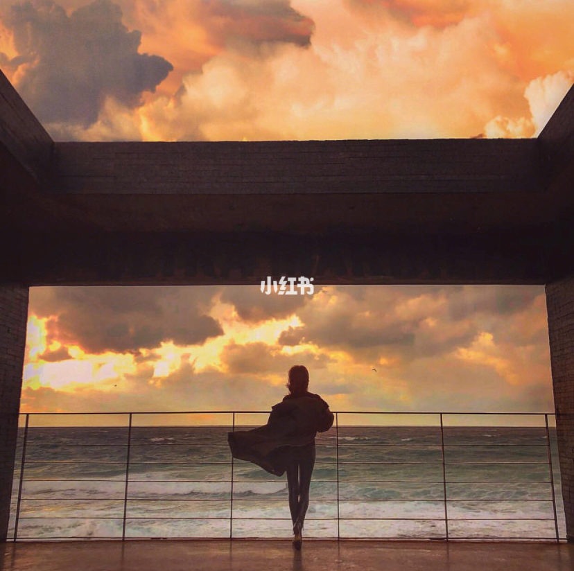 Girl overlooking the sea with sun set