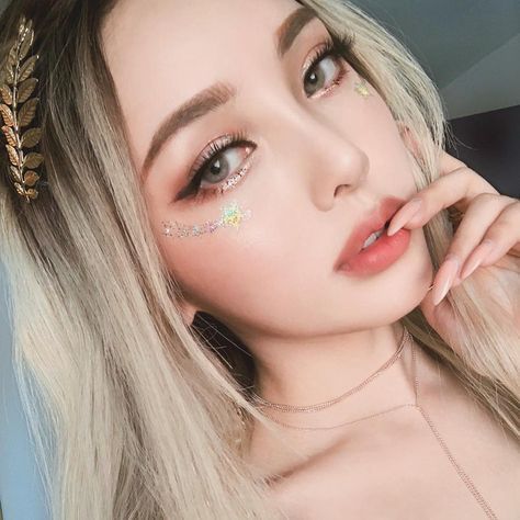 asian girl with blonde hair and chunky glitter highlight
