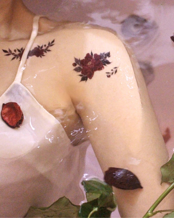 Floral tattoos on collarbone and shoulder