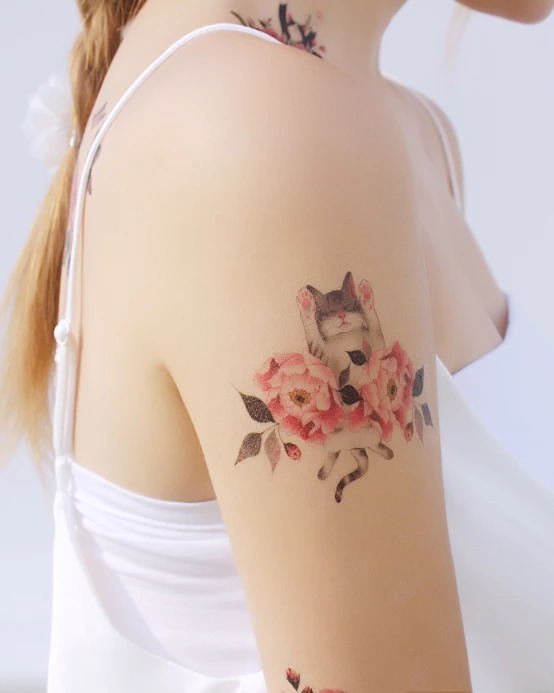 Floral and cat tattoo on the arm